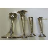 Pair of silver candlesticks together with two single candlesticks, all hallmarked silver and with