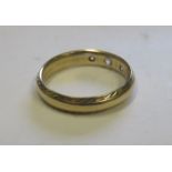 A marked 375 gold triple diamond ring with a canted pattern border, ring size N ½, weight 3.1g