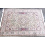 A new green ground keshan style rug decorated with a central medallion and floral border 2m x 1.4m