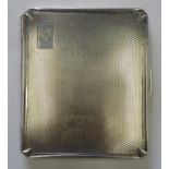 Silver cigarette case with engine turned design and the initials M.C engraved to the top right,