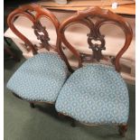 A pair of mahogany upholstered dining chairs together with a single chair