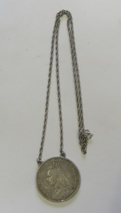 A silver crown dated for 1899 on a white metal chain necklace