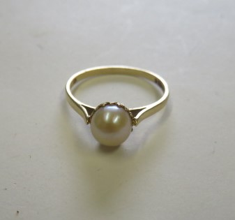 A 9ct gold pearl (untested) dress ring, with faded hallmarks, ring size O, weight 1.4g