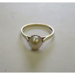 A 9ct gold pearl (untested) dress ring, with faded hallmarks, ring size O, weight 1.4g