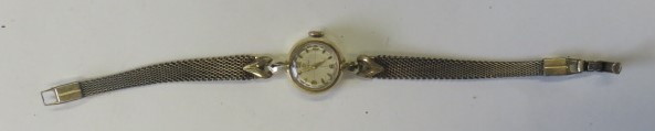 Omega - a ladies vintage gold cased wristwatch on a tapered smooth metal chain strap