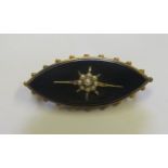 A Victorian memorial brooch marquise shaped with an unmarked yellow metal surround, the front set in