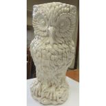 A white ceramic umbrella stand in the form of an owl