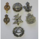 Seven territorial cap badges including 7th Battalion Hampshire Regiment, Durham ligh infantry, 4th