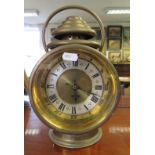 A mantel clock in the form of a brass coach lamp by Thomas Harrington & Sons.