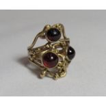 A 9ct gold statement ring set with three boules of Rhodolite Garnet glass, rubbed hallmarks, ring