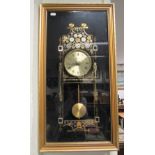 Gilt framed quartz wall clock featuring watch parts.