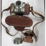 A Veto B 35mm camera with spare lens etc together with a miniature minetta camera all in a leather