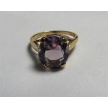 A marked 375 gold, amethyst cocktail ring set with a large faceted oval amethyst measuring approx