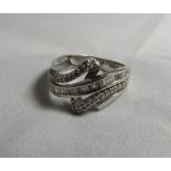 A channel set diamond geometric ring in white metal, probably platinum - marked 050ct, ring size