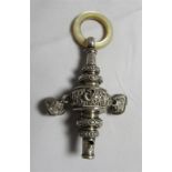 An Edwardian silver baby's rattle with whistle at terminal and a mother of pearl handle.