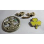 A pair of sapphire set gilt metal clips together with a yellow three leaf clover badge, a