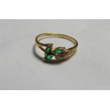 A marked 750 gold and green stone petal dress ring. Ring size Q 1/2, weight 2.5g