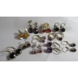 11 pairs of gem and stone set earrings to include Baltic amber, smoky quartz and amethyst. Some