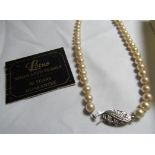 A cased single strand lotus pearl necklace with guarantee and receipt