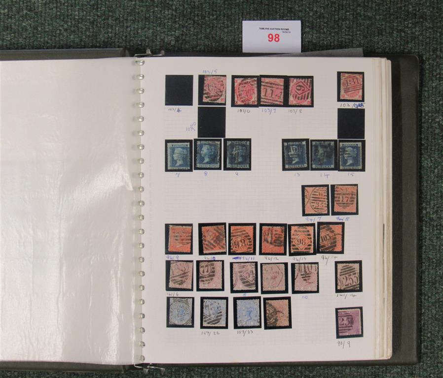A dark green album with a collection of British stamps, Victoria to Queen Elizabeth II