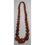 Old amber choker necklace made of graduated beads in various shades to include honey, cherry and