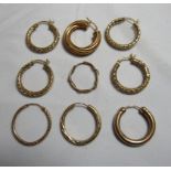 Two matched pairs of marked 9ct or 375 gold hoop earrings together with two marked 9ct gold single