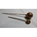 A marked 15ct gold face stick pin, centrally set with a seed pearl together with a unmarked gold/