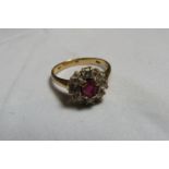 A gold, ruby and white stone flower head ring with faded marks ring size N, weight 3.7g