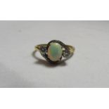 An unmarked gold (tested), platinum, diamond and opal cocktail ring with the opal measuring approx