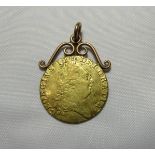 A 1787 George III gold guinea coin with a rose gold scroll top suspender for pendant. Gross weight