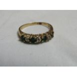 A gold, green stone and diamond accent dress ring with faded marks, size O, weight 2g