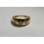 An 18ct gold, triple diamond gypsy set ring, hallmarked Chester, indistinct date letter and faded