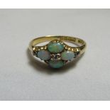 An 18ct gold, old cut diamond and opal dress ring, horizontally set with four opals, each