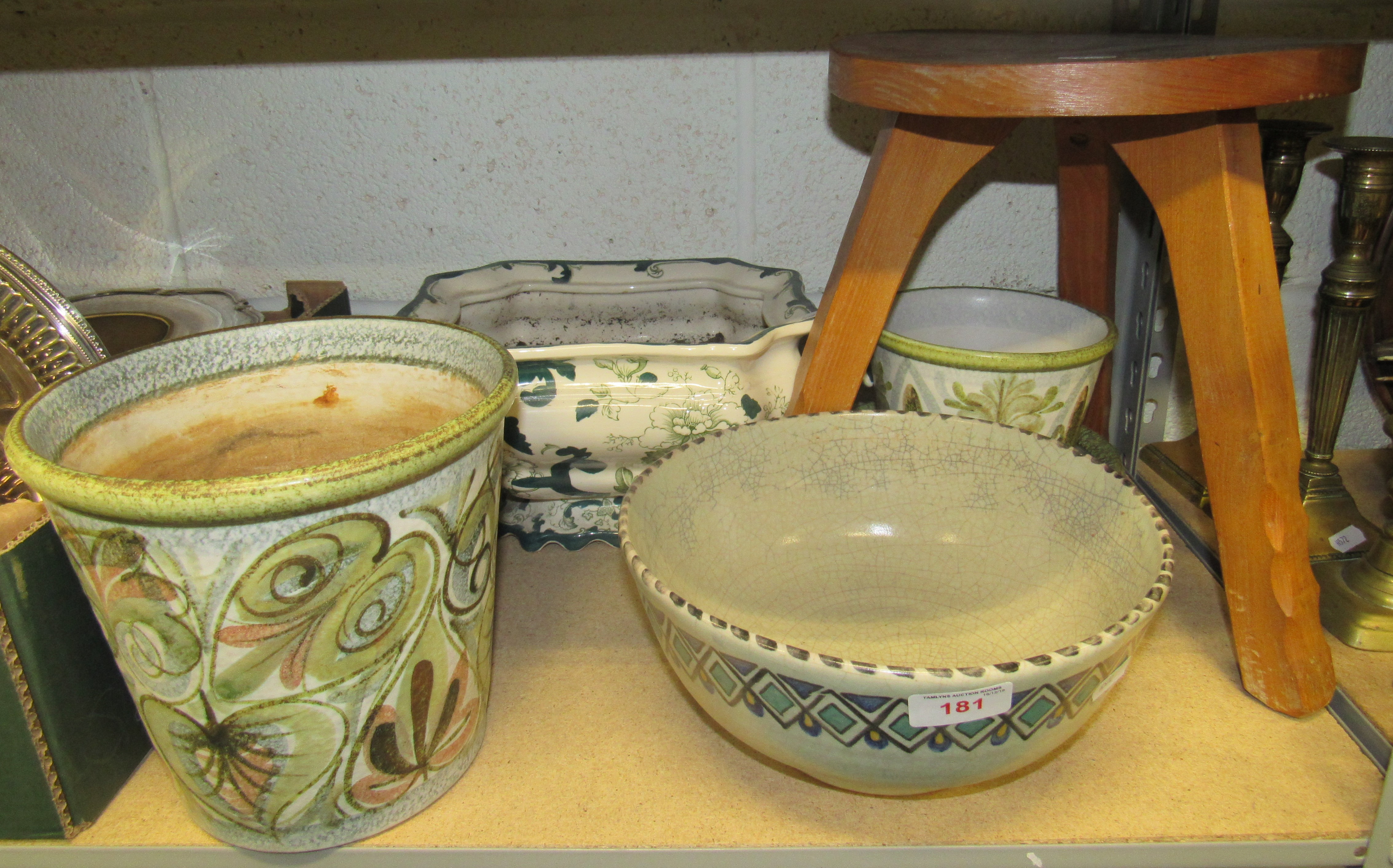 A pine three legged milking stool together with a Poole bowl and other ceramics including two