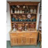 An early 19th century pine dresser, with two tiered plate rack with hanging hooks above a base