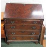 A mahogany writing bureau with key and with compartments to the interior and with four drawers