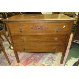 A three drawer oak chest of drawers standing on legs and with pear drop handles