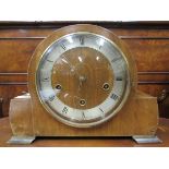 A wooden mantel clock with roman numerals