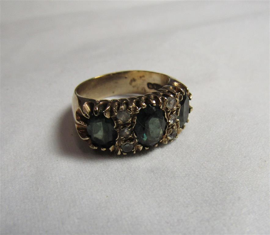 A 9ct gold green and white stone dress ring with the central oval faceted green stone measuring