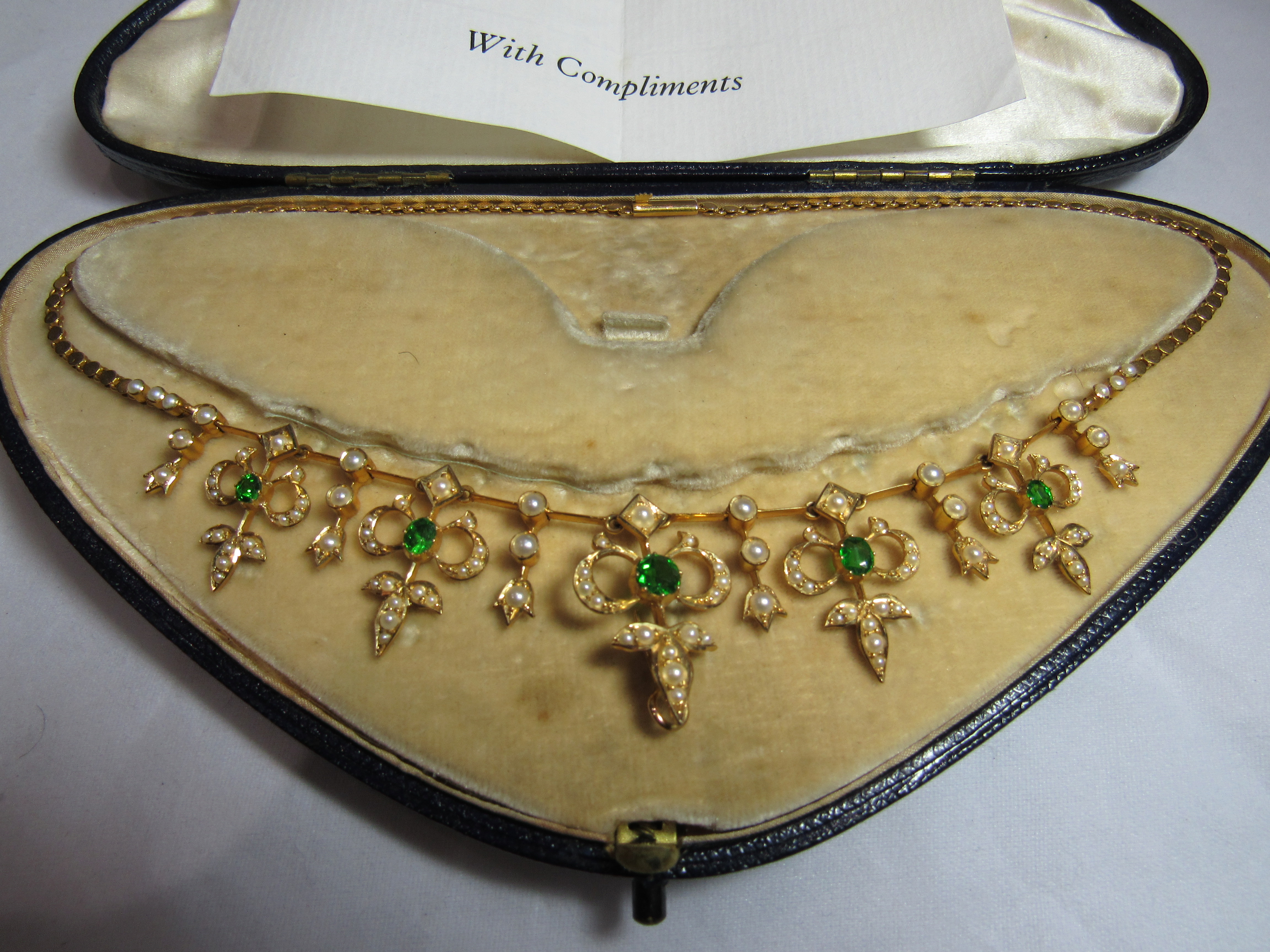 An unmarked gold (tested) seed pearl and green stone collar necklace measuring 38.5cm in length. - Image 2 of 2