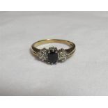 A 9ct gold, sapphire and diamond accent dress ring with faded markings. Ring size O, weight 2.3g.