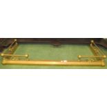 A brass coloured metal adjustable fire fender surround