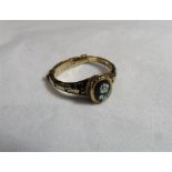 A Victorian unmarked gold (tested) mourning ring with a small black laquered signet panel with white