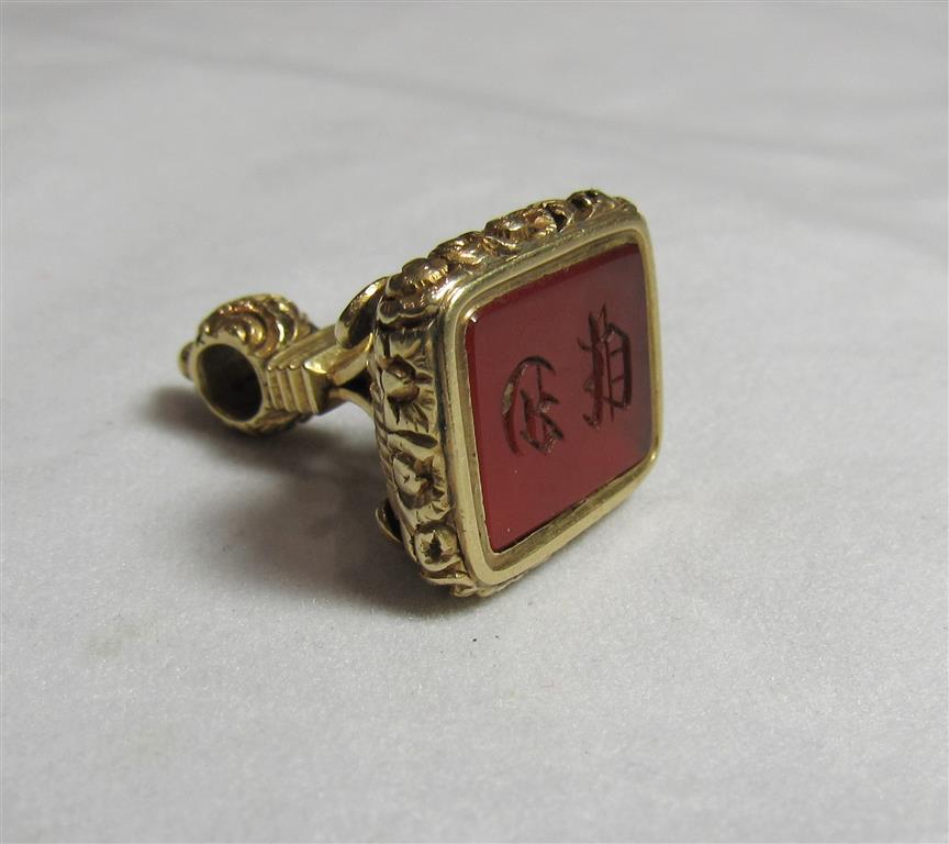 A 19th or early 20th century gold or gilt orange hard stone seal fob/pendant with the case
