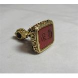 A 19th or early 20th century gold or gilt orange hard stone seal fob/pendant with the case