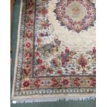 A rug of blue and red oriental design with border and on a cream background and with small fringed