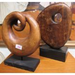 Two wooden sculptures on stands