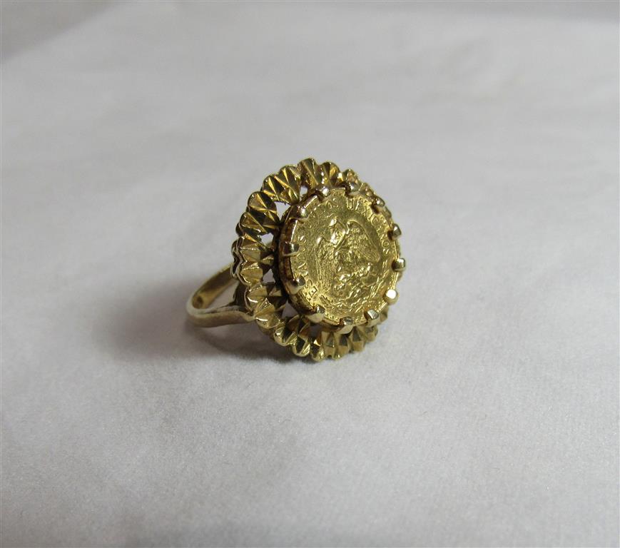 A 1945 Mexican Peso gold ring with the shank marked 375 and the coin coronet set and raised on a