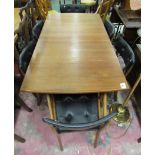 A Teak extendable dining table with matching 4 chairs and 2 carvers and with black upholstery