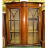 A glass fronted double door mahogany display cabinet with inlaid beaded decoration and bow